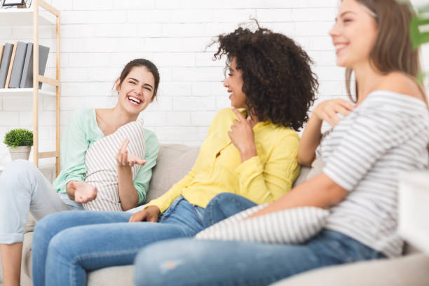 istock Happy friends chatting at home, having friendly talk 1128657630