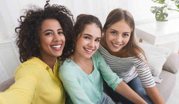 istock Diverse friends enjoing time together, taking selfie 1128657632