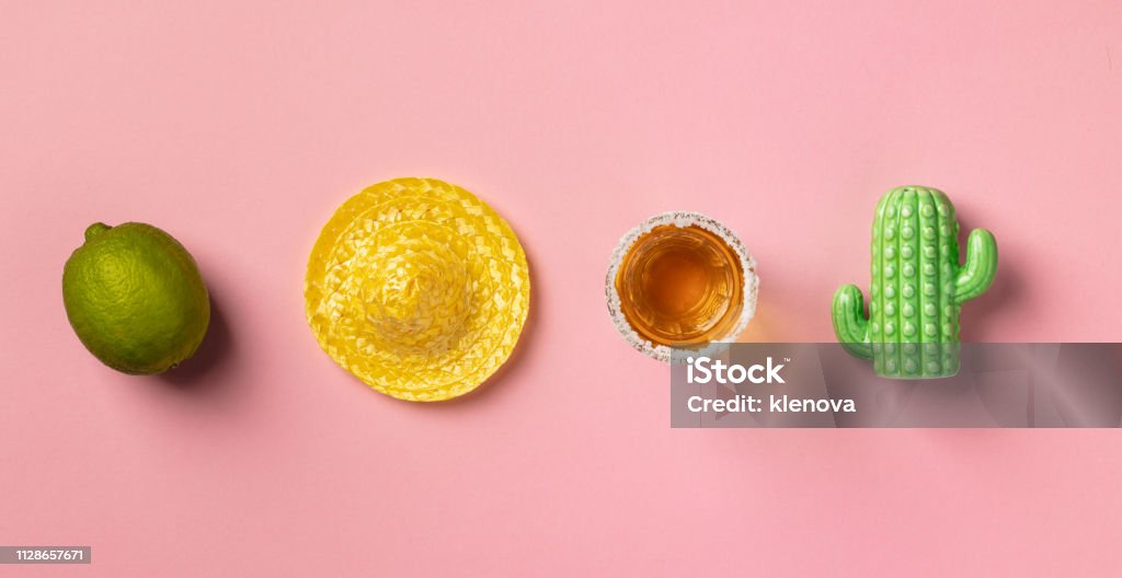 Sombrero, lime, tequila and cactus on pink background. Sombrero, lime, tequila and cactus on pink background. Creative mexican tradition concept. Flat lay composition Mexico Stock Photo