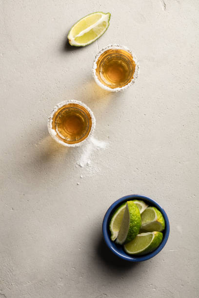 istock Gold tequila with lime and salt, flat lay 1128657678