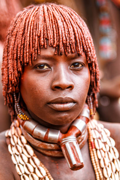Hamar tribe Omo valley Ethiopia Turmi, Omo River Valley, Ethiopia - December 25, 2010: Portrait of a Hamar lady in her village during a bull jump ceremony. The Hamer are a primitive tribe and the women have many decorations. hamer tribe photos stock pictures, royalty-free photos & images