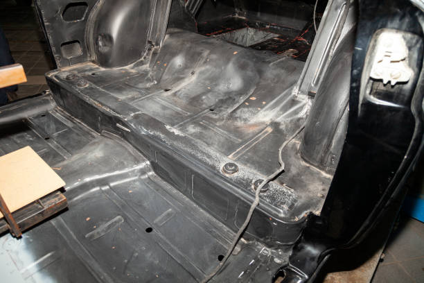istock Disassembled car body, inside a black sedan, with parts and interior elements removed, prepared for the restoration and replacement of sound insulation and interior trim. 1128661620