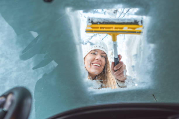 istock Woman clean car of snow view from inside 1128662877
