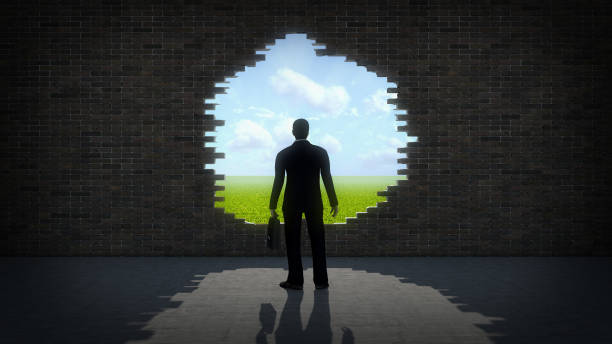 istock Businessman in front of a wall with a hole 1128662900