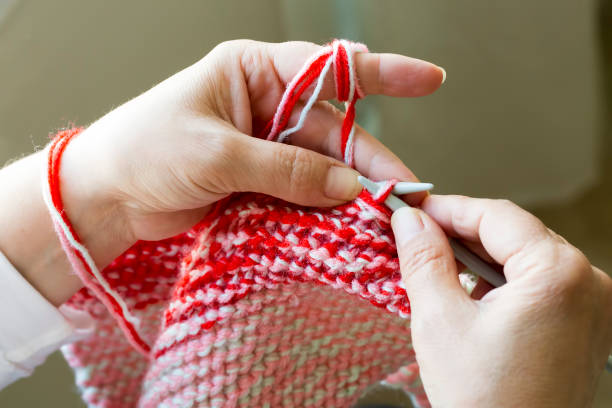 istock Woman knitting needles web of light wool yarn. Knitting needles. 1128663715