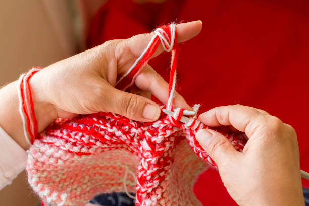 istock Woman knitting needles web of light wool yarn. Knitting needles. 1128663748