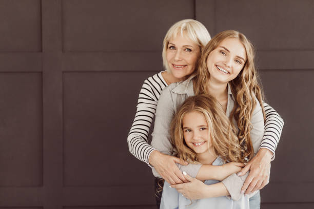 istock Three generations of happy women looking at camera 1128663782