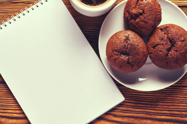Cup of coffee cup with crunchy cookie on the table and smart phones\