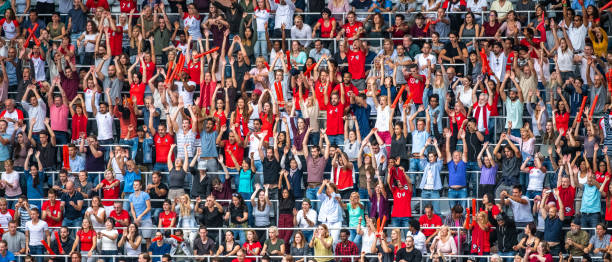 crowds with hands up cheering their team - arquibancada imagens e fotografias de stock