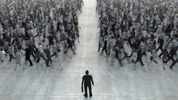 istock Businessman standing in front of a crowd of competitors 1128665054