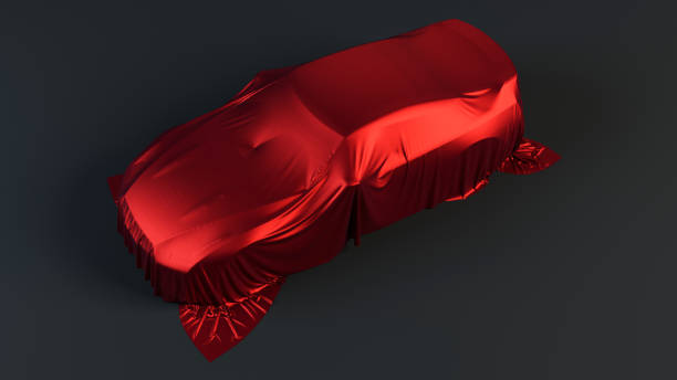 istock New car is covered with red drapery 1128665878