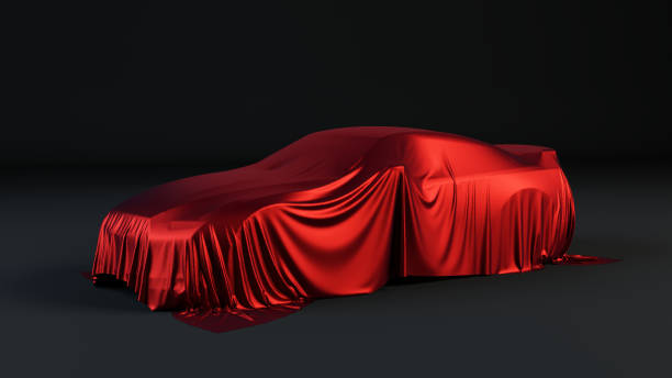 istock New car is covered with red drapery 1128665889