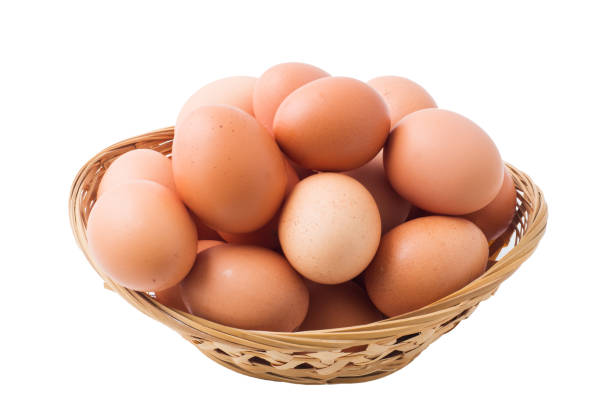 istock Chicken eggs in basket on isolated white background. 1128666188