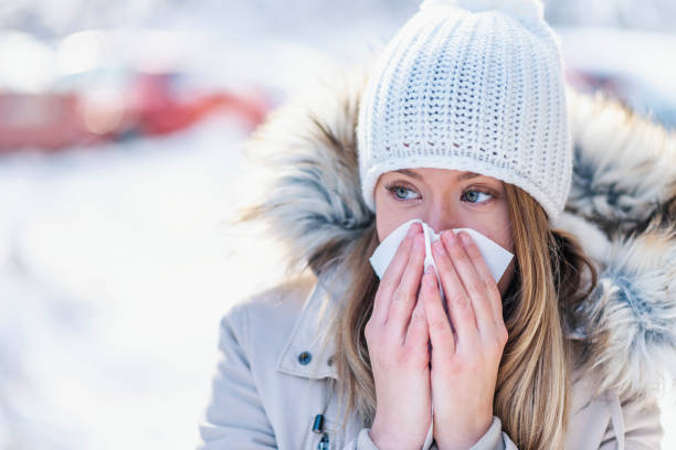 istock Girl with allergy symptom blowing nose 1128666227