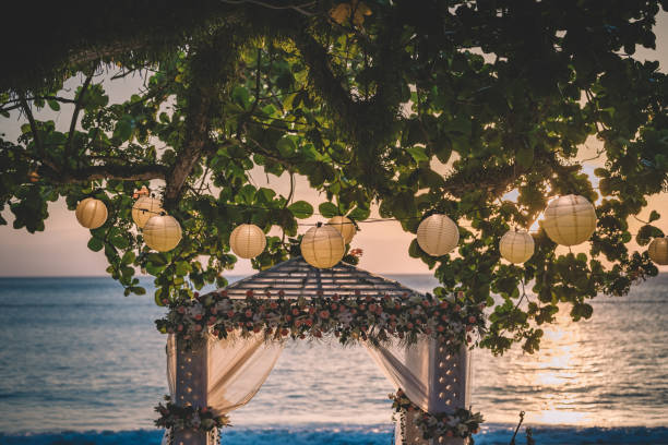 istock beach during sunset magic hour with a canopy beside the tree with lantern decoration 1128668201