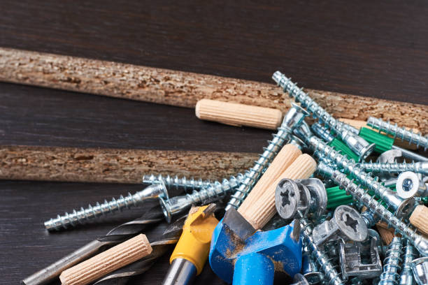 istock Tools for furniture assembly on a wooden background closeup 1128668497