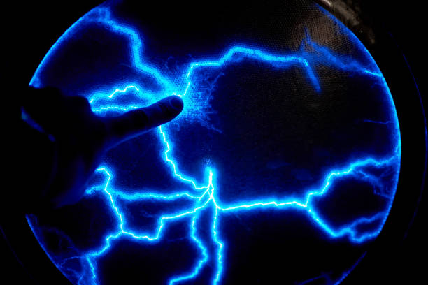 istock Finger touch electric plasma ball on a dark background. Static electricity model 1128668526