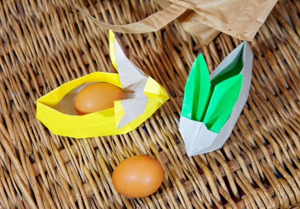 istock Handicraft origami rabbits from paper. Easter bunnies. Creative package for gift 1128669666