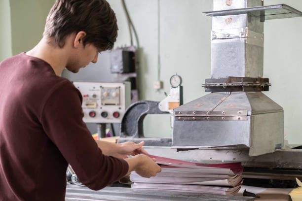 istock worker at the typography printing newspaper or journal b 1128670179