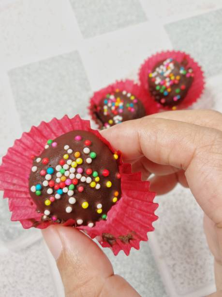 istock Chocolate ball, sweet snack, with color chip topping 1128671475