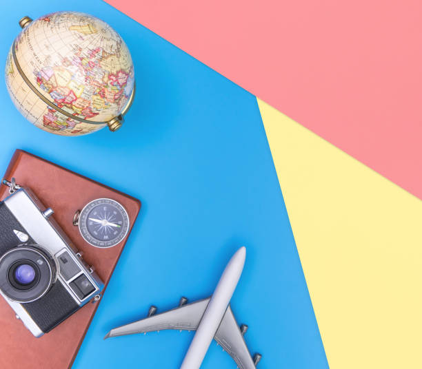 istock Travel accessories objects and gadgets top view flatlay on blue yellow pink 1128671841