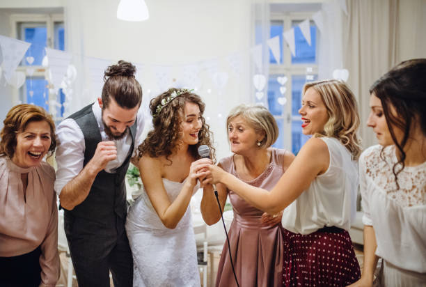 istock A young bride with other guests dancing and singing on a wedding reception. 1128671864