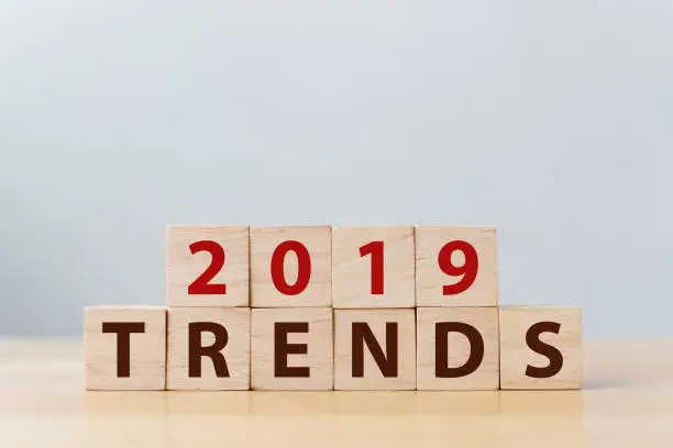 Photo of 2019 trend concept. The word TRENDS on wooden cube block