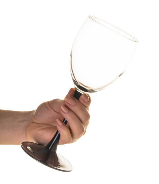 istock empty wine glass in female hand 1128673466