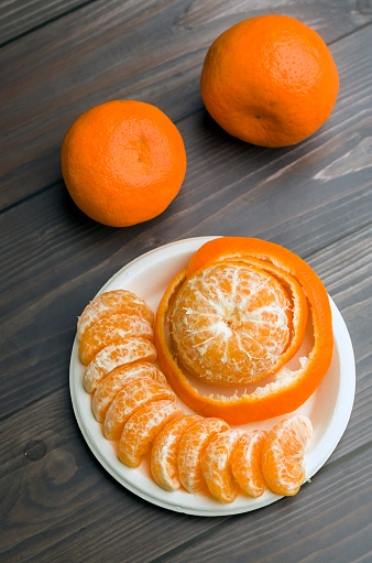 Fresh organic mandarins on rustic wooden table