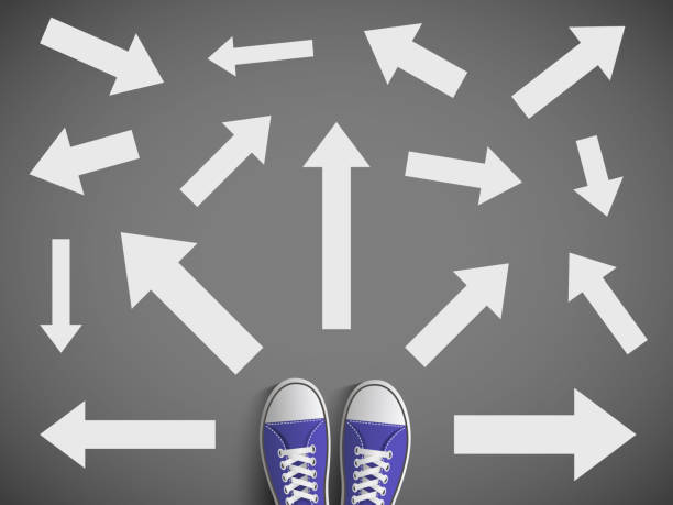 istock Man standing on the road with many arrows. Direction of way. 1128675179