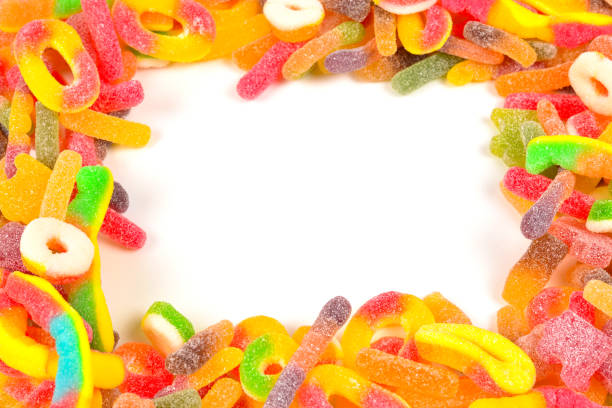 istock Frame of assorted gummy candies isolated on white. Top view. Space for text or design. 1128677181