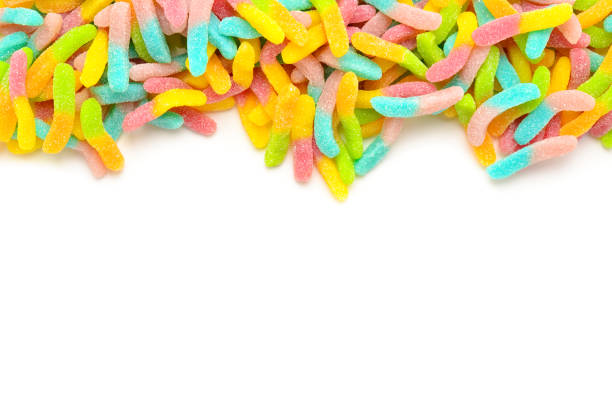 istock Frame of assorted gummy candies isolated on white. Top view. Space for text or design. 1128677215