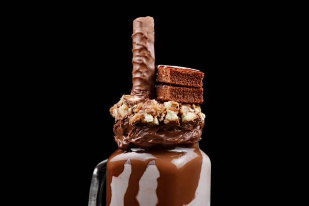 istock Chocolate extreme milkshake with brownie cake, chocolate paste and sweets. Crazy freakshake food trend. Copy space 1128677235