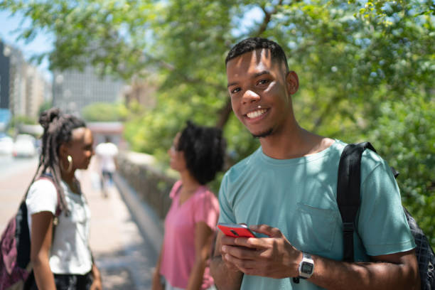 istock Afro Latin Boy Using smartphone in the city 1128677272