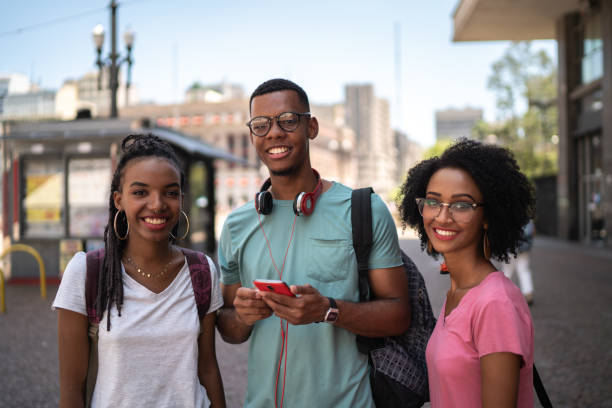istock Young latinx group using smartphone in the city 1128677274