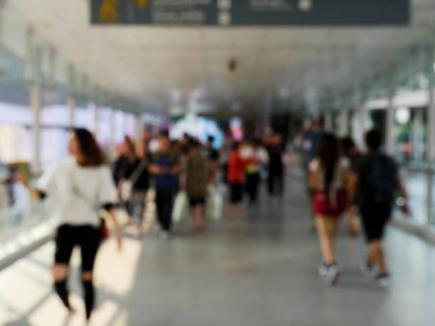 istock Blurred image of the people are walking on the floating bridge. 1128678800