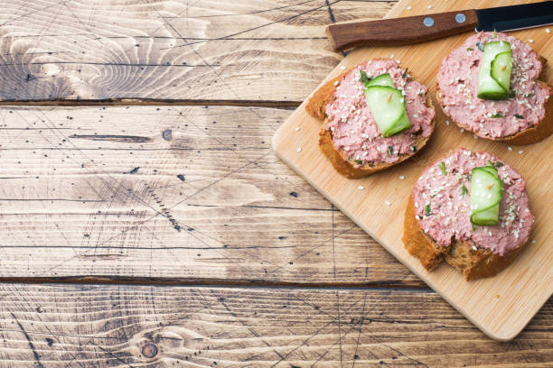 istock Sandwiches with chicken pate and cucumber on wooden table. Copy space 1128680722