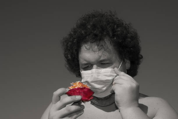 istock Allergy to flowers. Funny man. 1128681841
