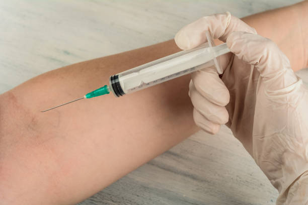 istock Doctor giving an injection to a patient. 1128683006