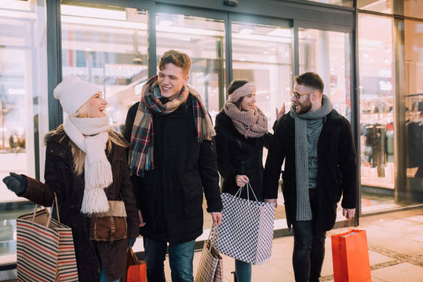 istock Young people shopping together 1128683434