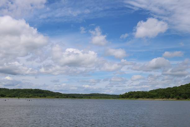 istock blue sky and white cotton clouds over the lake 1128684012