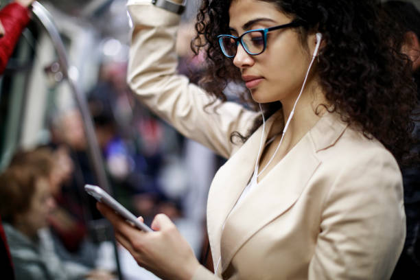 istock Businesswoman using mobile phone in the subway train 1128684021