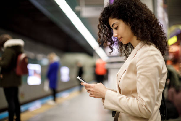 istock Female commuter at train station 1128684065