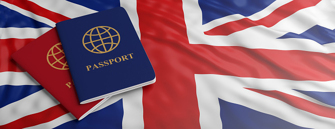 Travelling to UK, immigration or tourism. Two passports on United Kingdom flag background, banner, copy space. 3d illustration