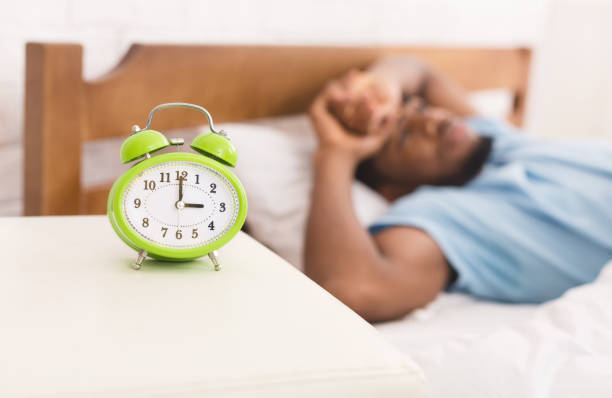istock Black man in bed suffering from insomnia and sleep disorder 1128684589