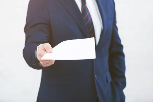 istock Businessman stretching paper for signature, light background 1128686101