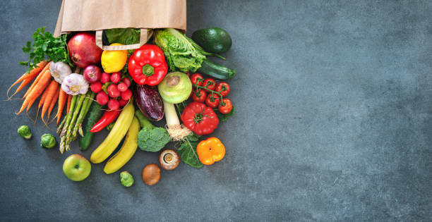 Shopping bag full of fresh vegetables and fruits Healthy food selection. Shopping bag full of fresh vegetables and fruits. Flat lay food on table raw diet stock pictures, royalty-free photos & images