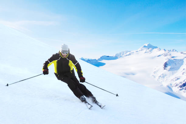 istock Alpine skier on piste running downhill 1128687500