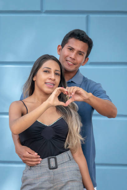 istock Young couple shows a heart with their hands 1128689521