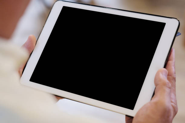 istock Senior man hand holding tablet with blank on screen display background, senior people and technology display montage, mock up, template, background 1128690419